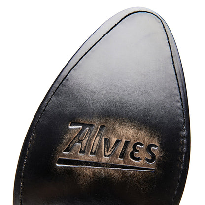 Black cowboy boot heel tab with metallic-style embossed brand lettering