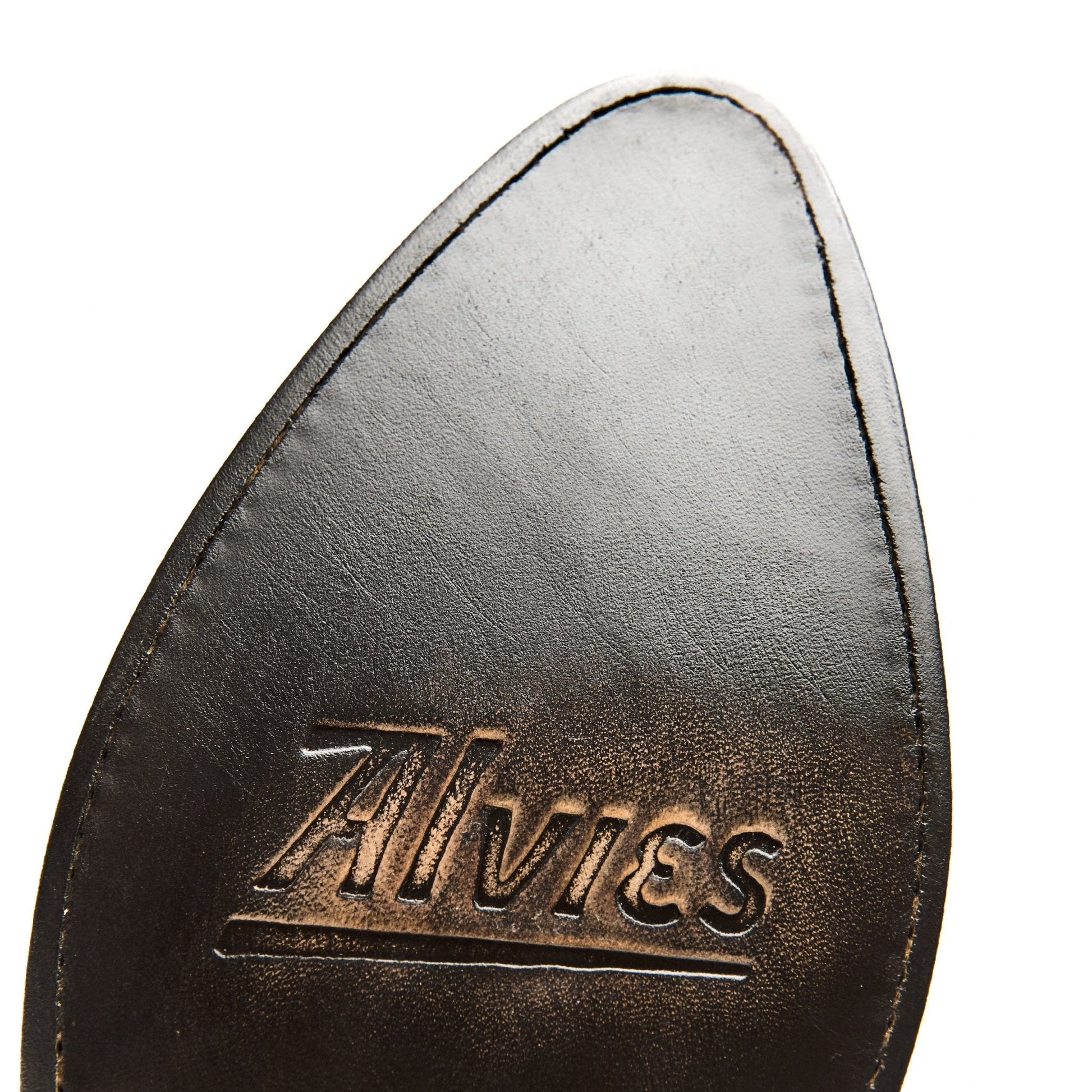 Brown leather cowboy boot lining close-up with gold logo text