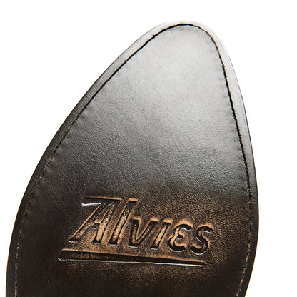 Brown leather cowboy boot lining close-up with gold logo text