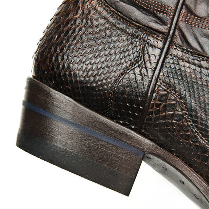 Brown leather cowboy boot quarter and heel with scale texture and dark sole