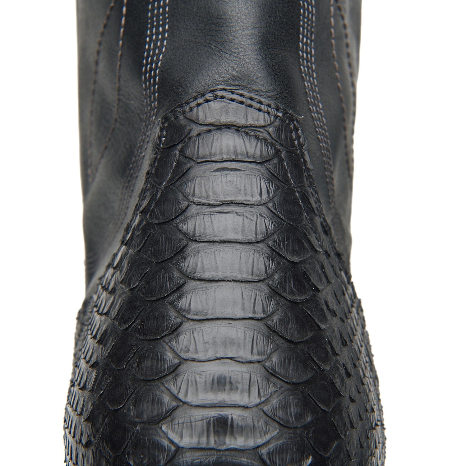 Black cowboy boot shaft with crocodile-style texture and stitched panel detail