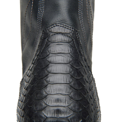 Black cowboy boot shaft with crocodile-style texture and stitched panel detail