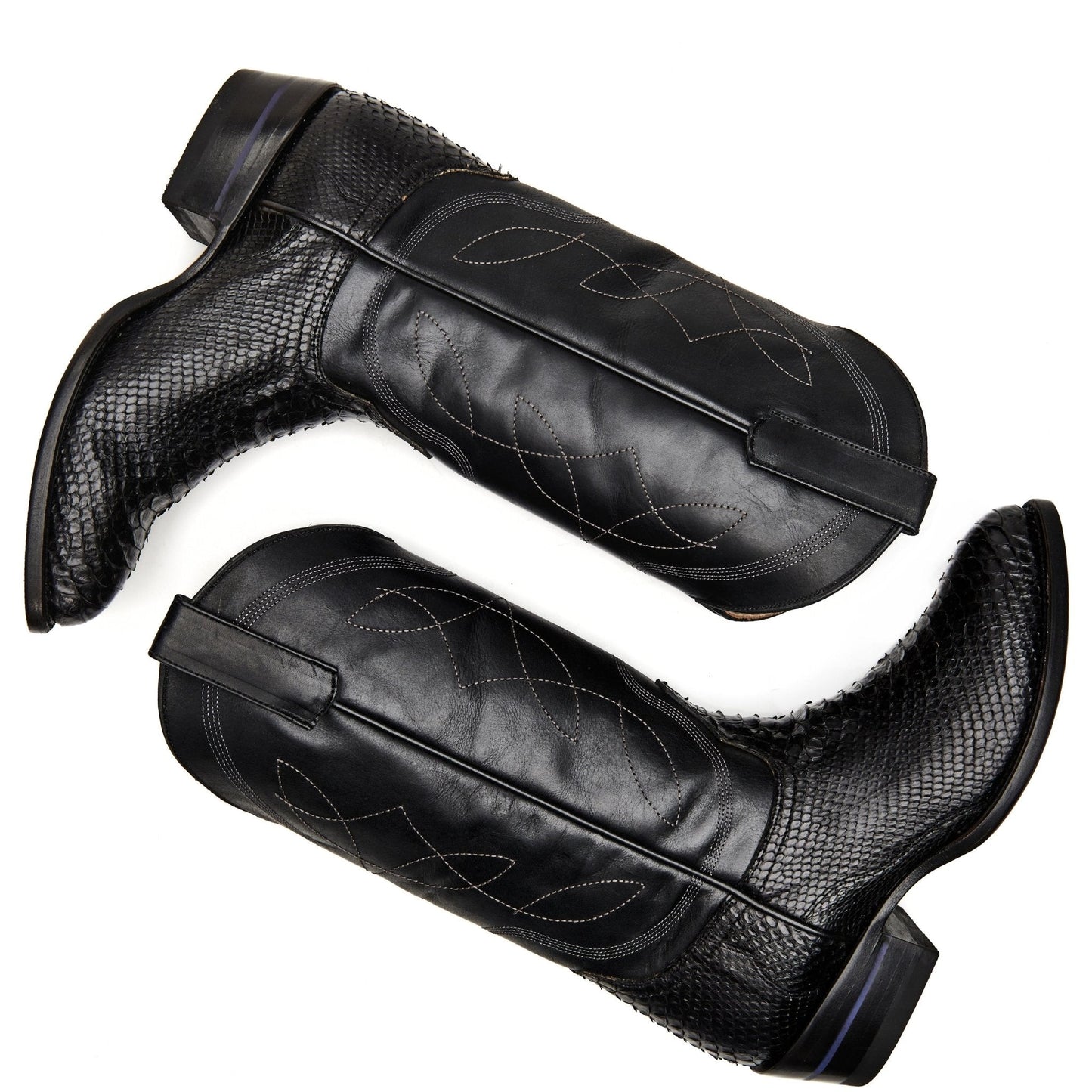 Black cowboy boot pair, textured shafts with decorative stitching and dark blue accents