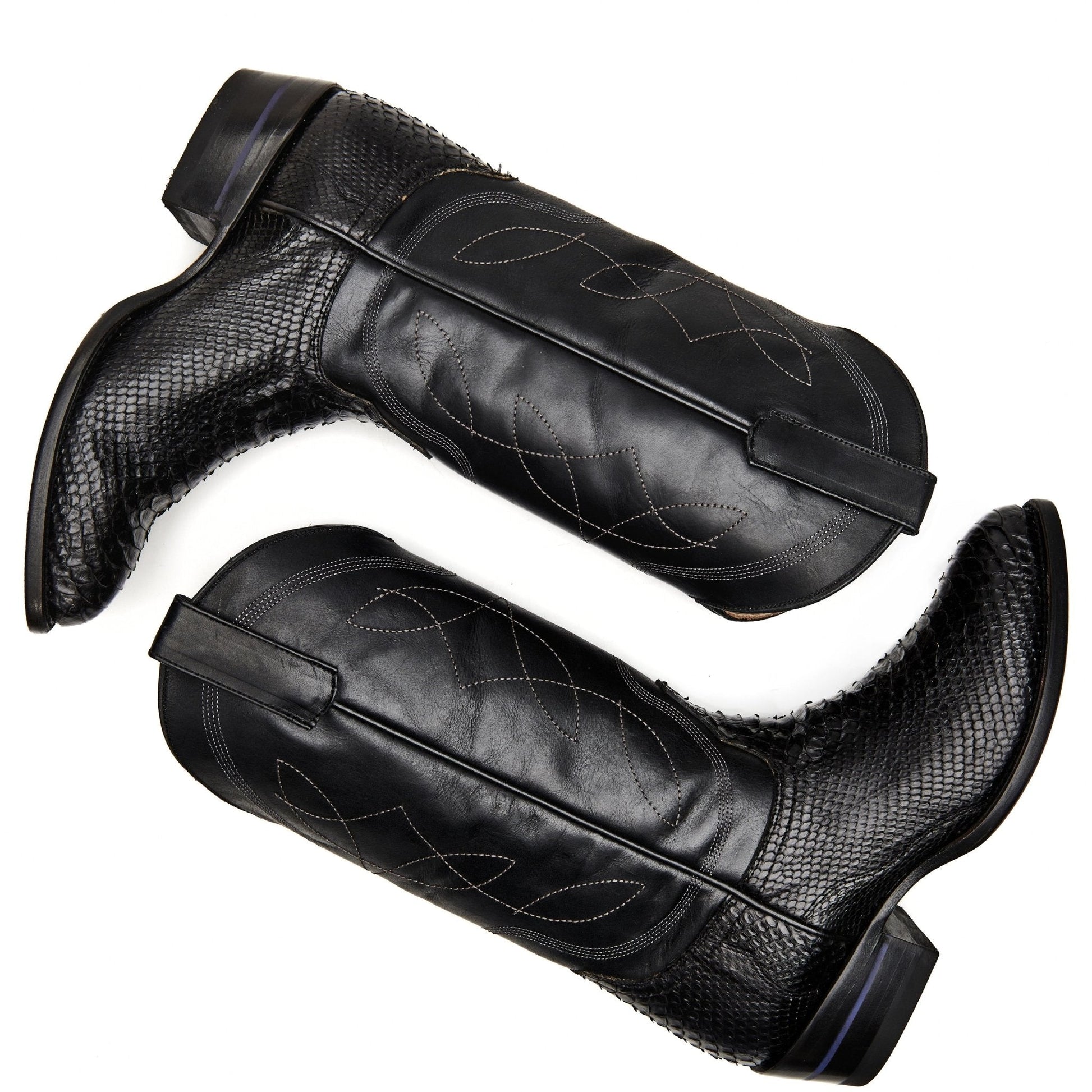Black cowboy boot pair, textured shafts with decorative stitching and dark blue accents