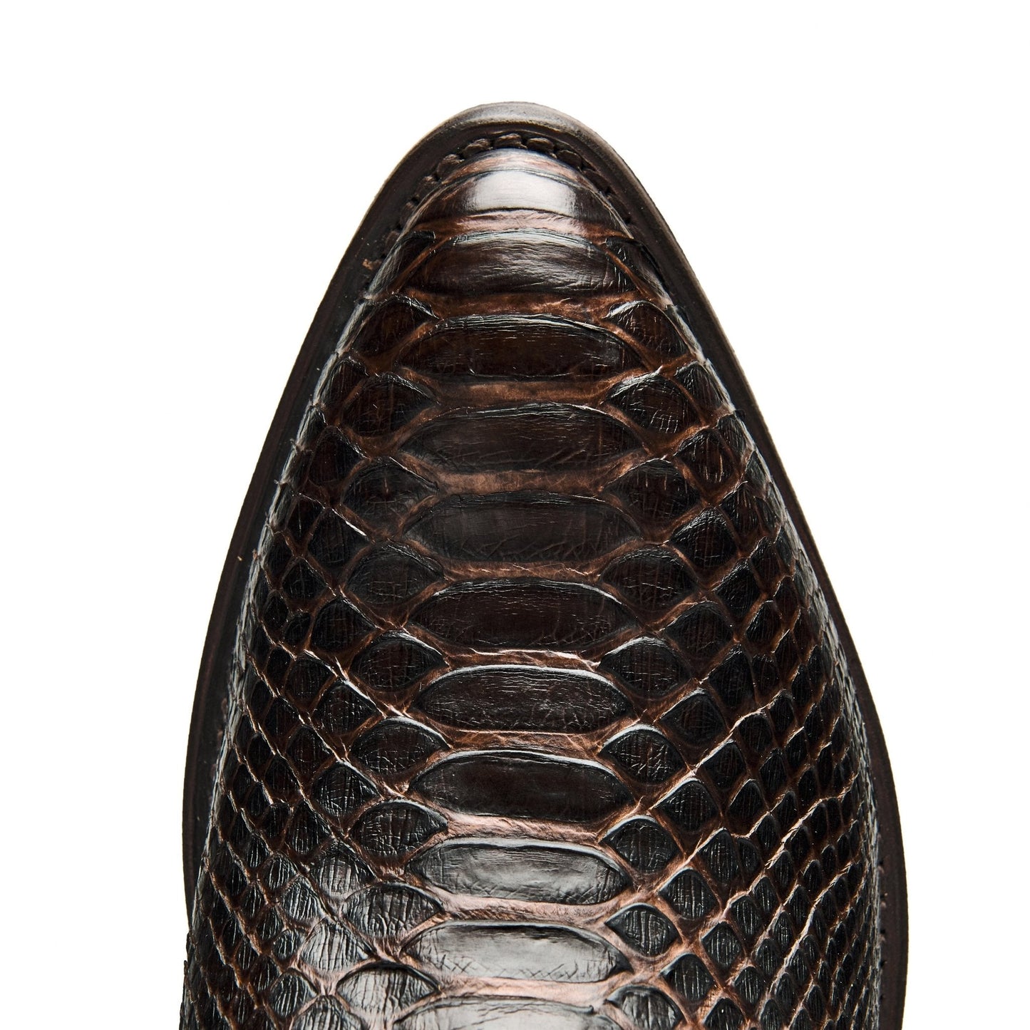 Brown leather cowboy boot toe and upper with textured scales and stitching detail
