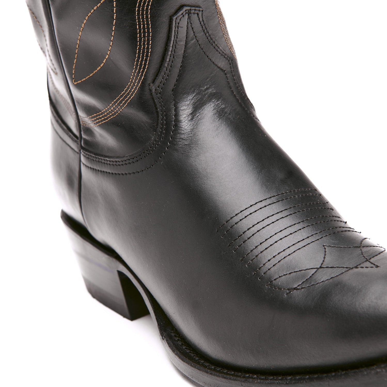 Black cowboy boot with cowboy-style stitched panels and low block heel