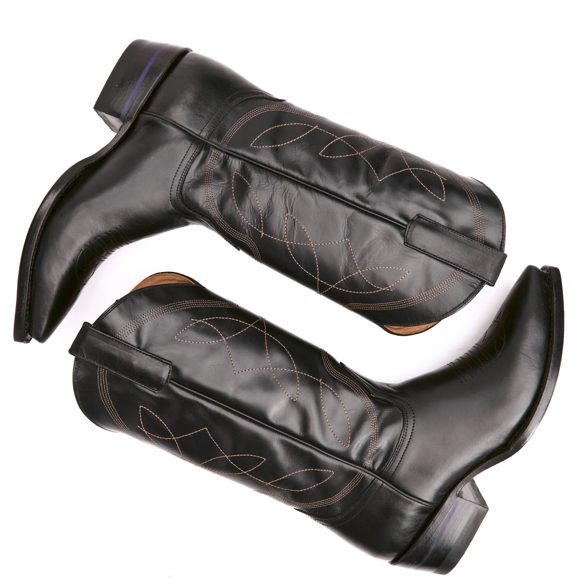 Pair of black pull-on cowboy boots with western swirl stitching and side straps