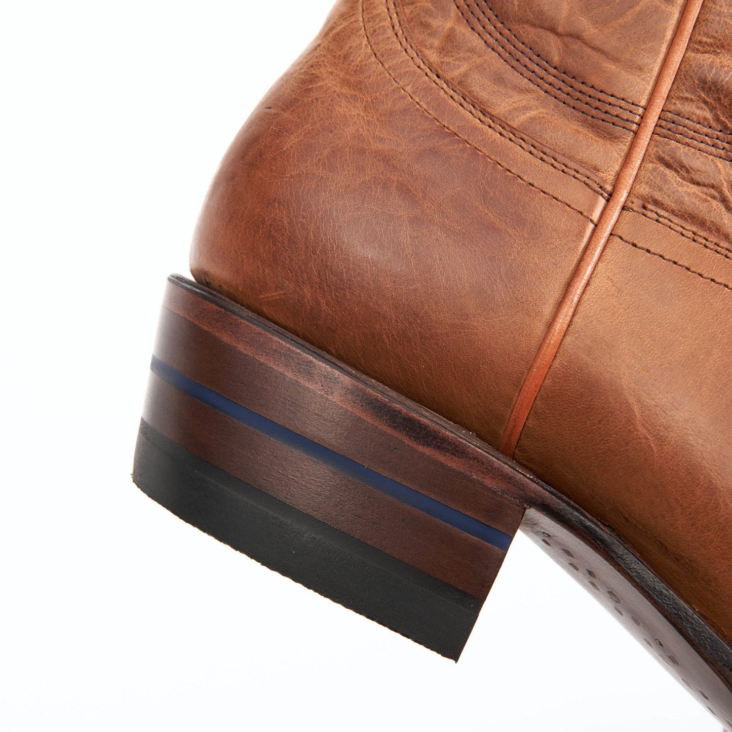 Honey brown leather boot heel with layered sole and blue stripe detail.