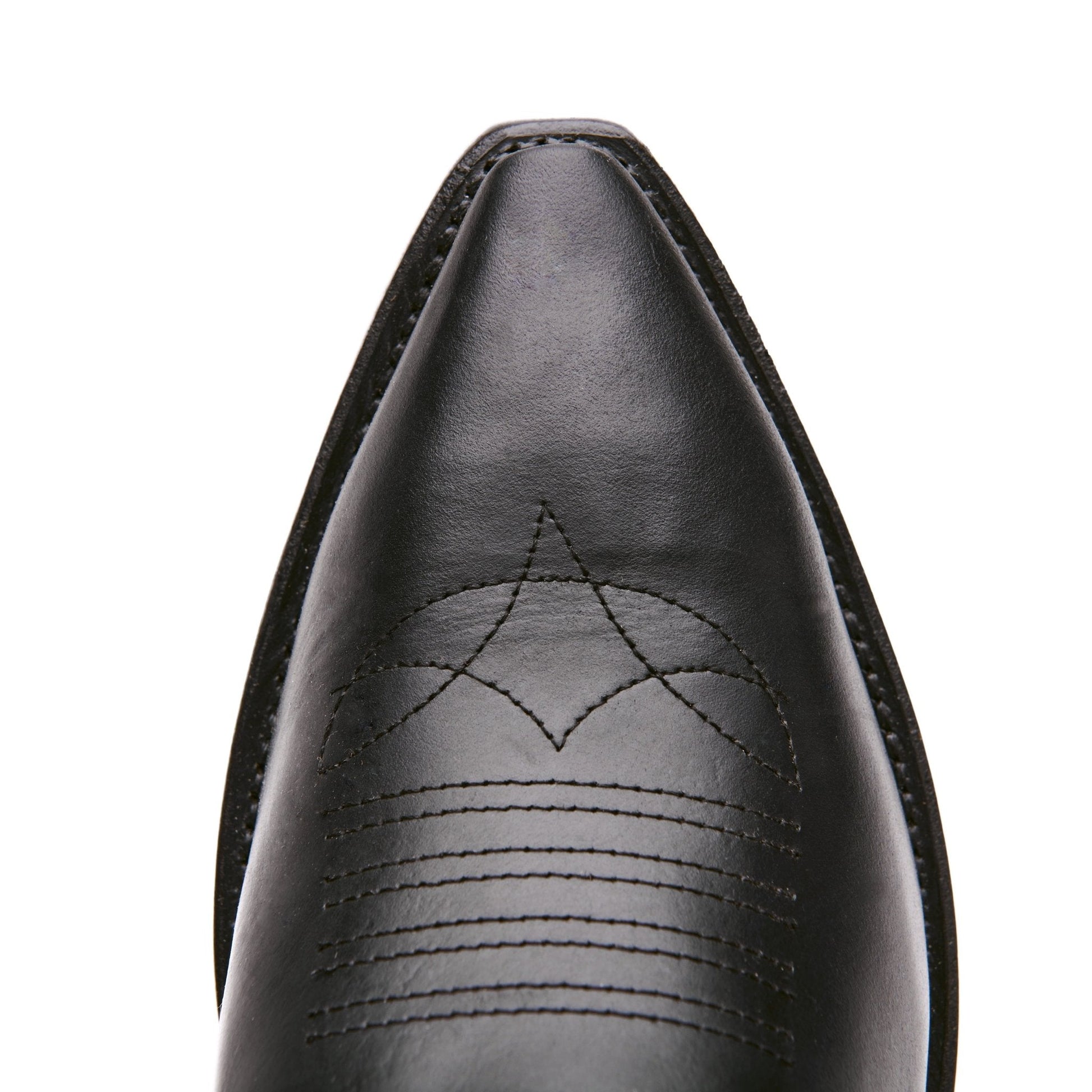 Black cowboy boot toe with stitched decorative arc pattern