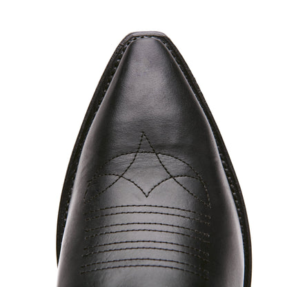 Black cowboy boot toe with stitched decorative arc pattern