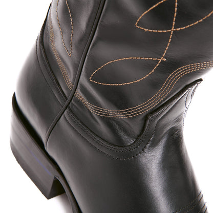 Black cowboy boot upper with tan stitch swirls near the ankle