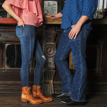 Cowboy boots in black and tan with western stitch detailing and pull tabs