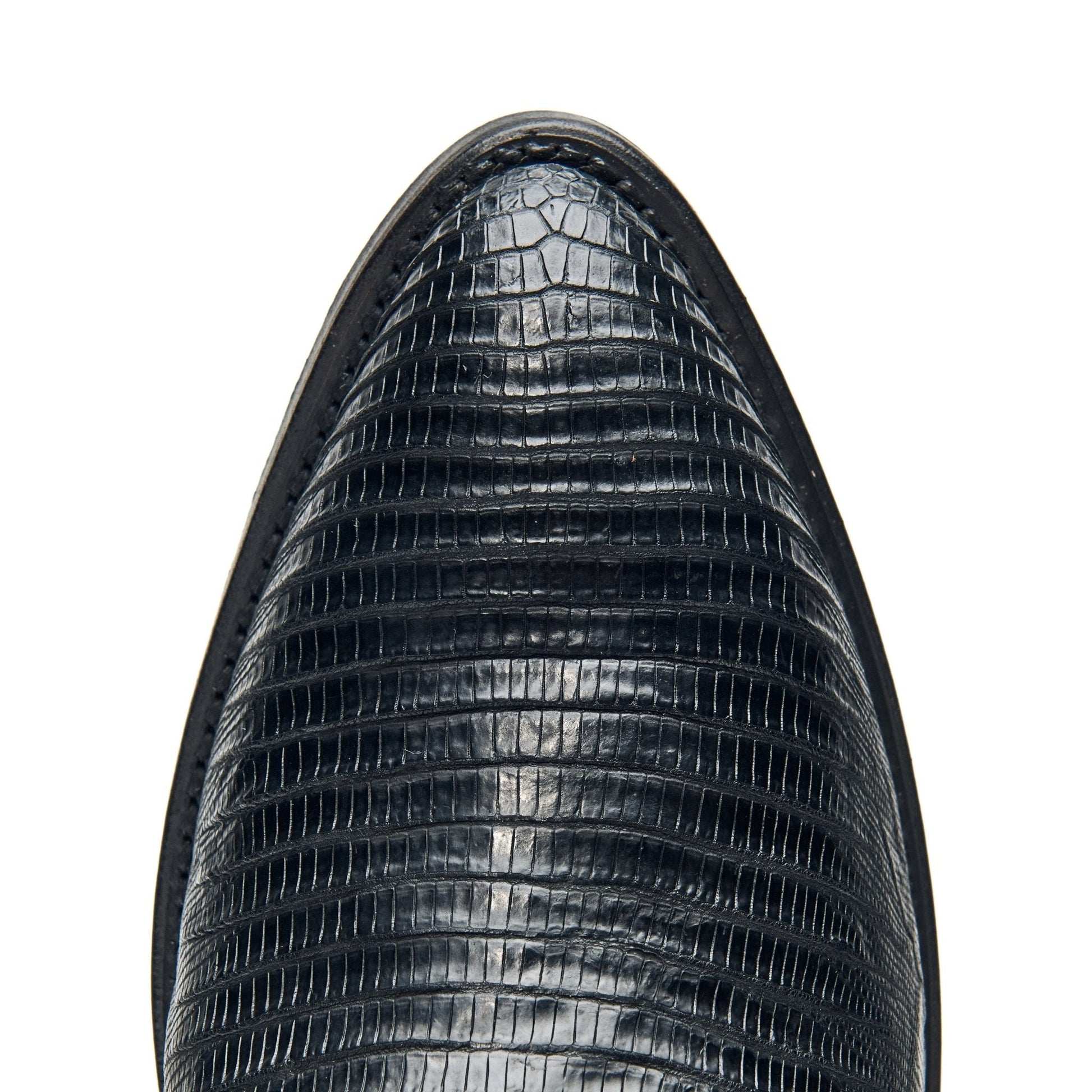 Black cowboy boot toe with alligator-style texture and smooth rounded edge.