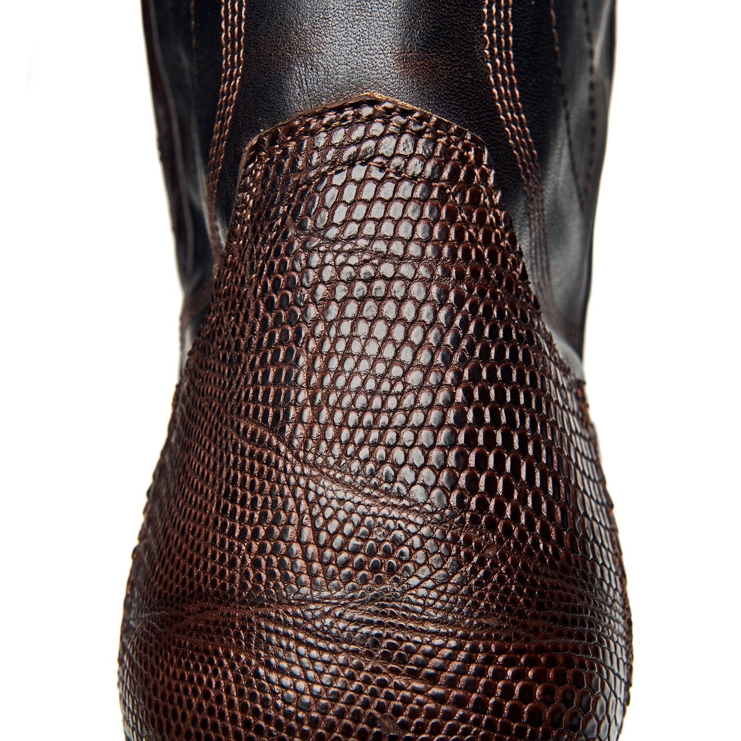 Dark brown cowboy boot shaft with scale-like texture and curved stitching details