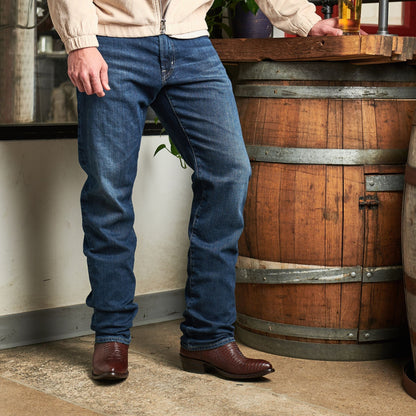 Brown cowboy boots with pointed toes and stacked heels on a standing person