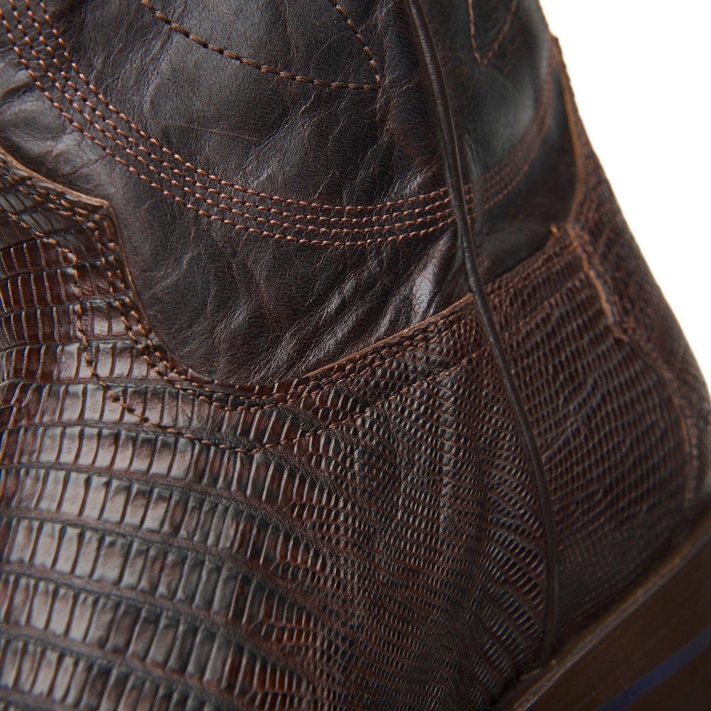 Dark brown cowboy boot quarter with stitched panels and detailed ankle seam