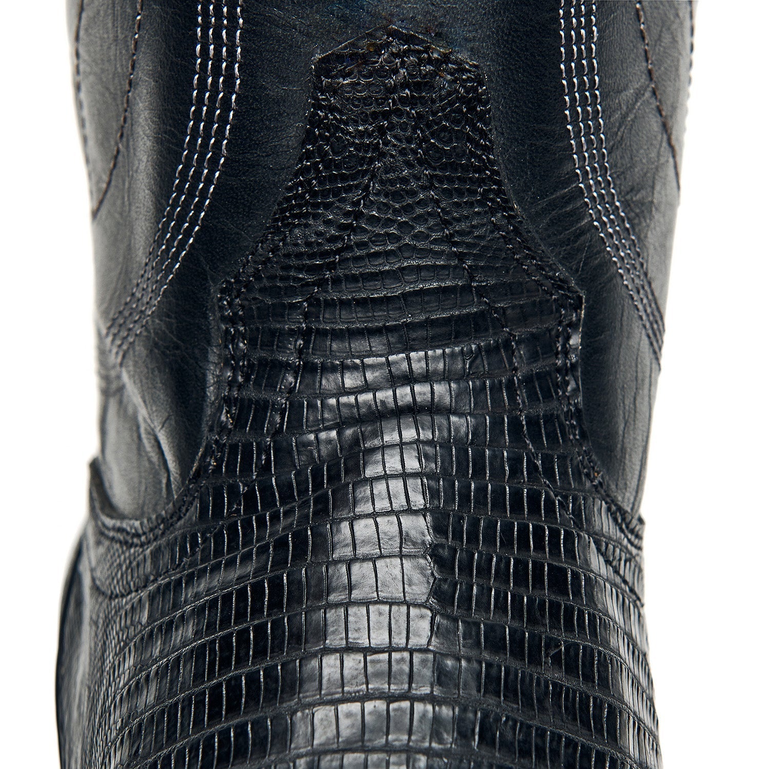 Black cowboy boot shaft with crocodile-style texture and stitched seam lines.