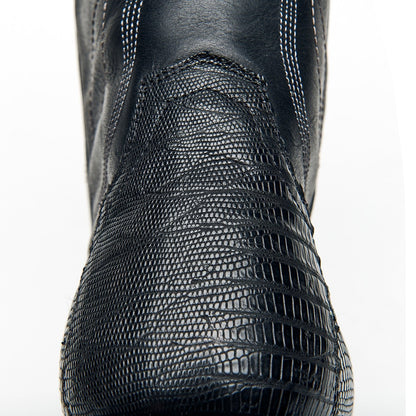 Black cowboy boot upper with fine textured surface and curved stitched overlay.