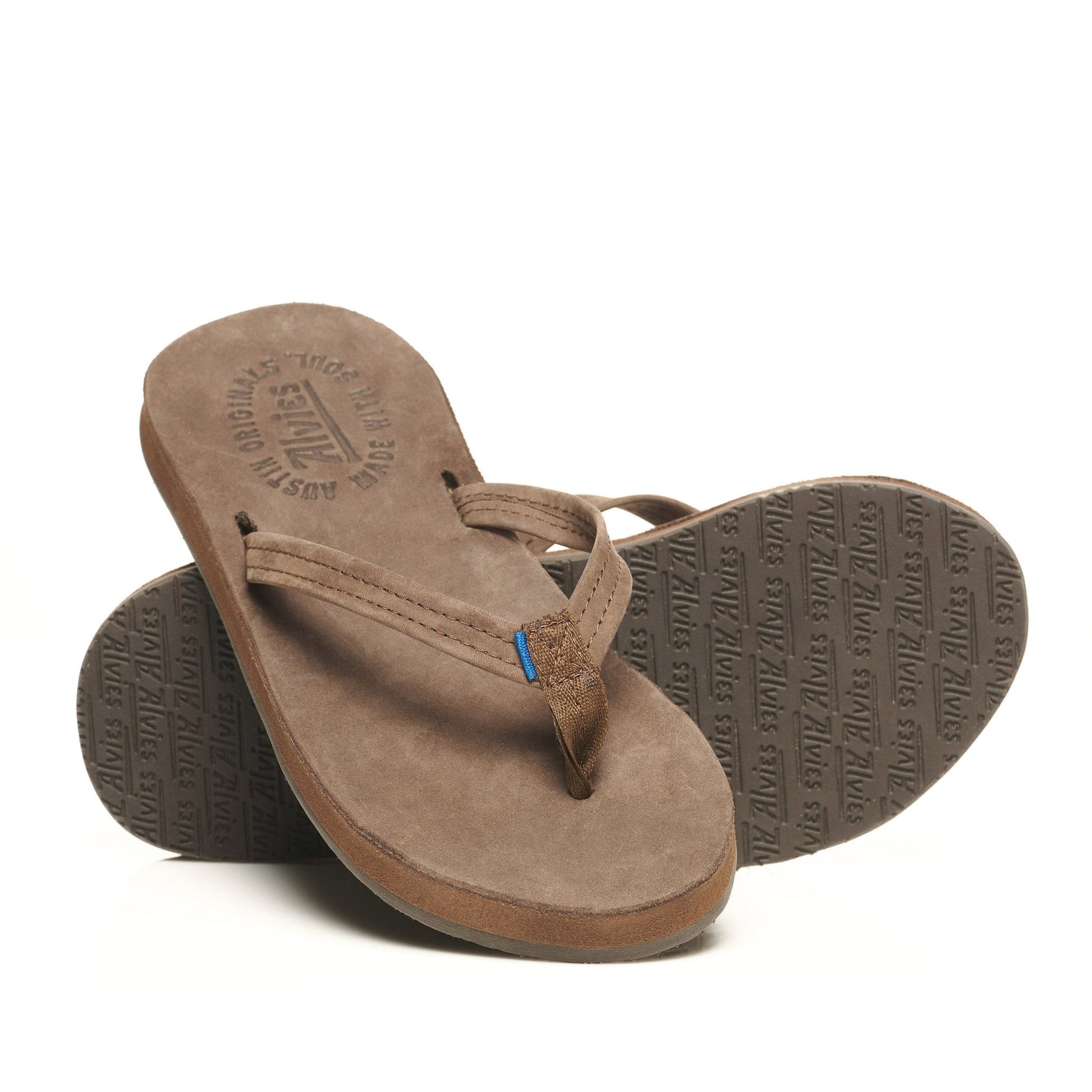 Brown suede flip-flops, one showing textured logo sole and blue toe strap