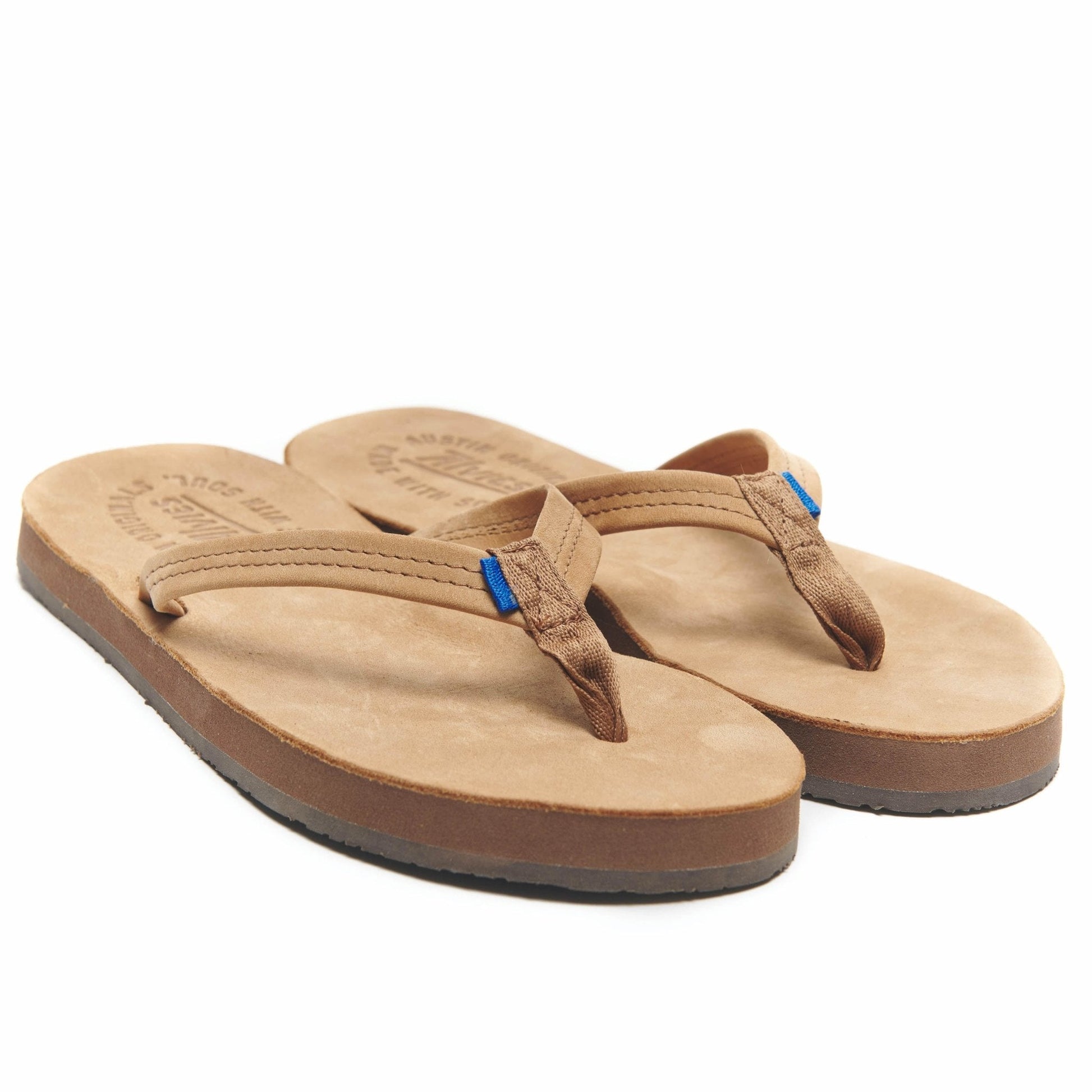 Tan flip-flops angled side view with brown thong and small blue accent tab