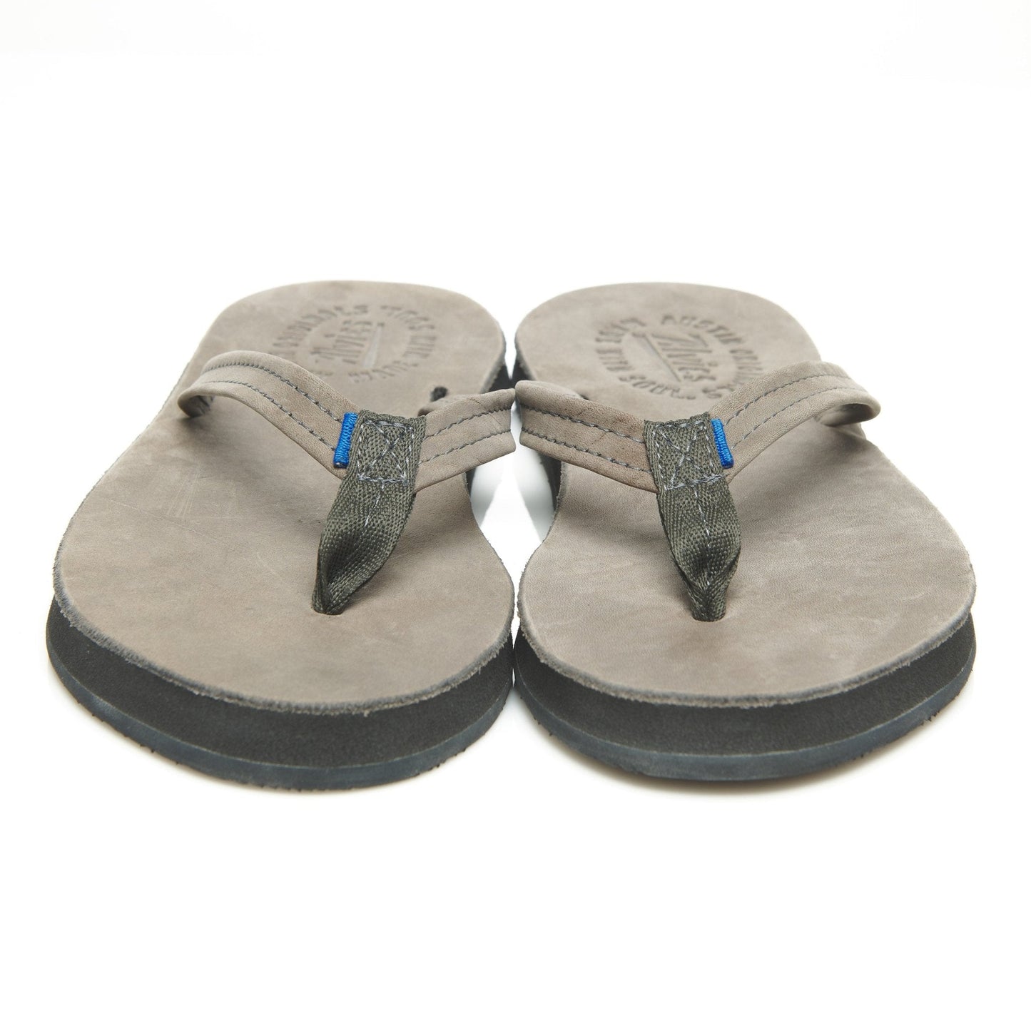 Pair of suede thong sandals, front view with gray rubber soles and blue strap tabs
