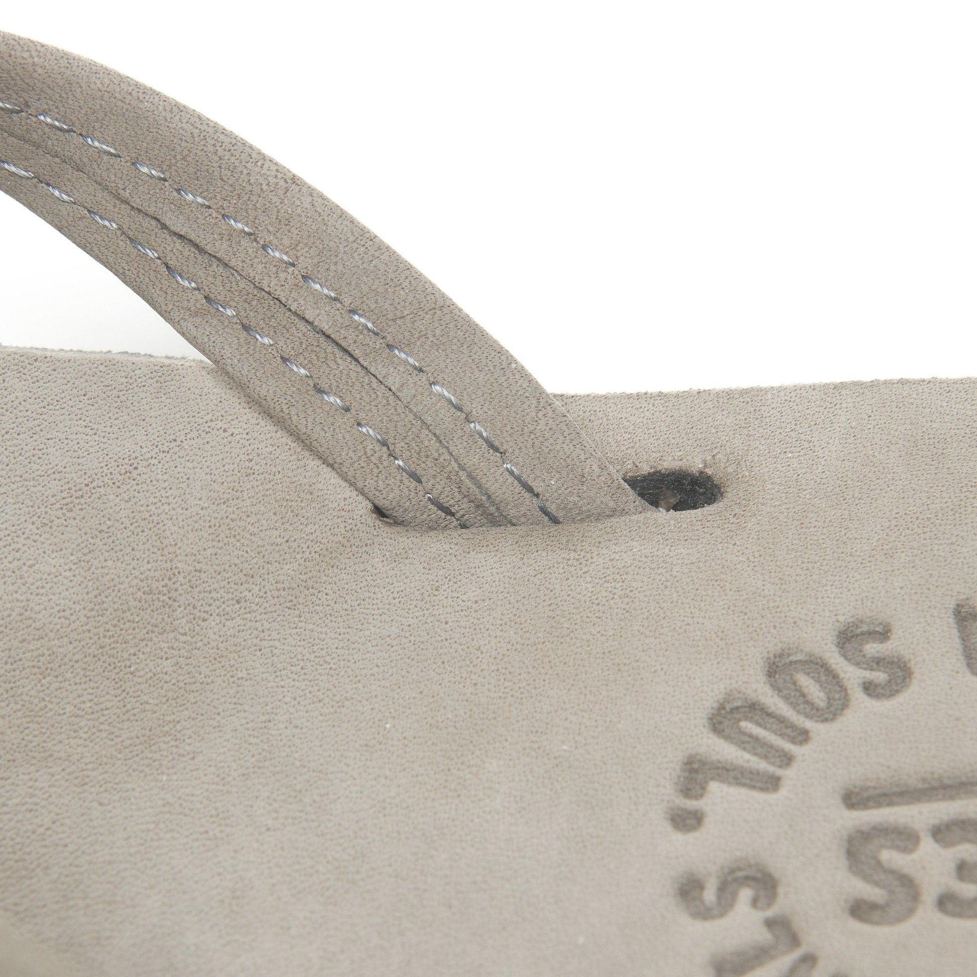 Thong strap with stitch detail; tan footbed with Austin logo.