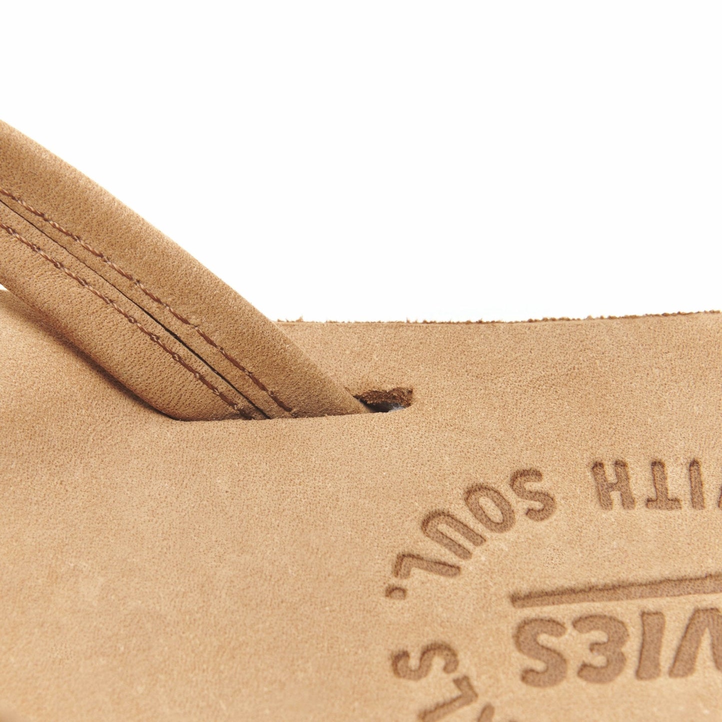 Tan flip-flop thong leather close-up with embossed logo on the insole