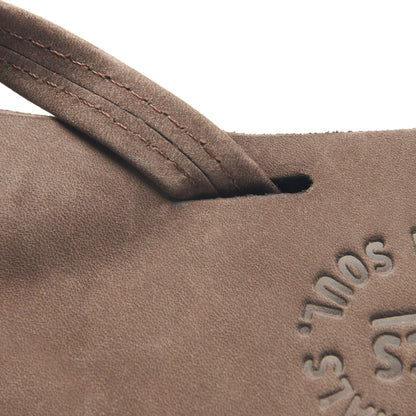 Suede flip-flop strap with stitching and embossed side branding; dark rubber sole