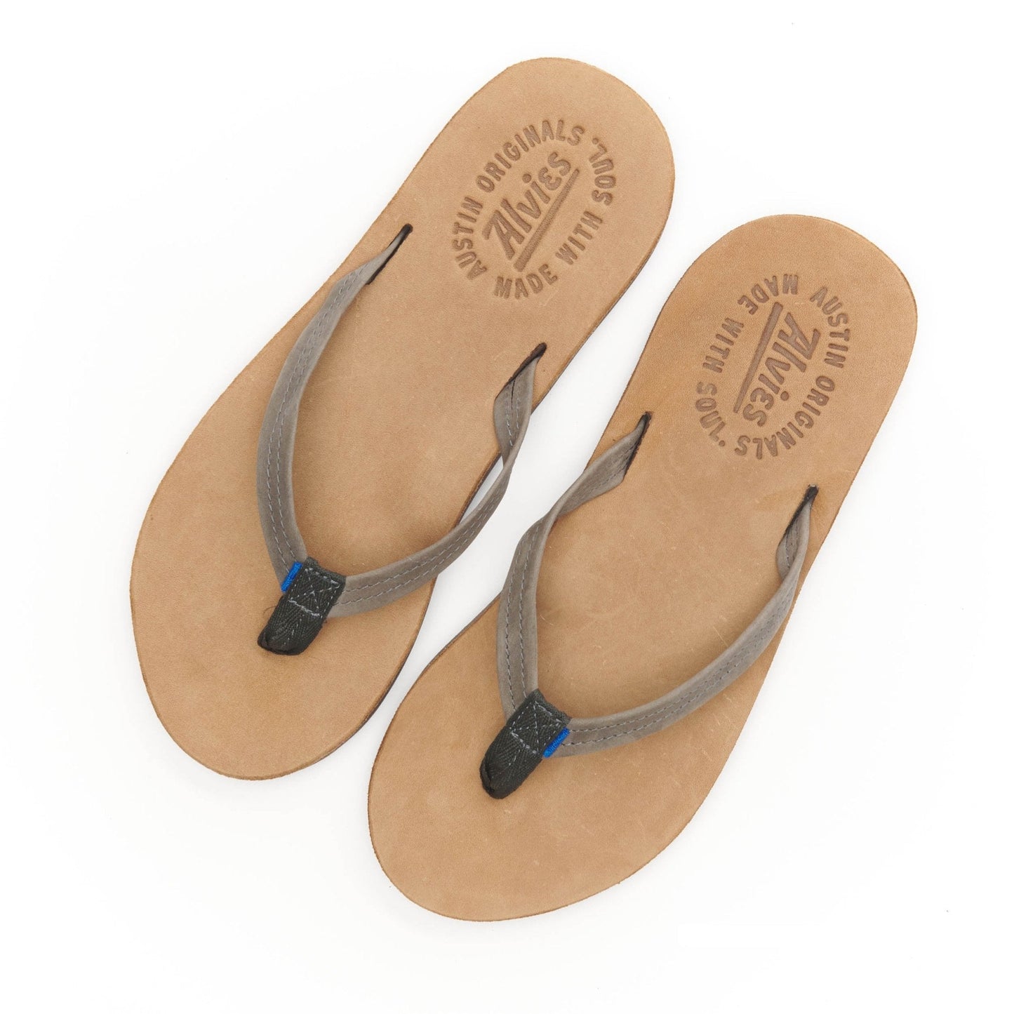 Pair of tan flip-flop sandals with gray straps and blue accents, top view