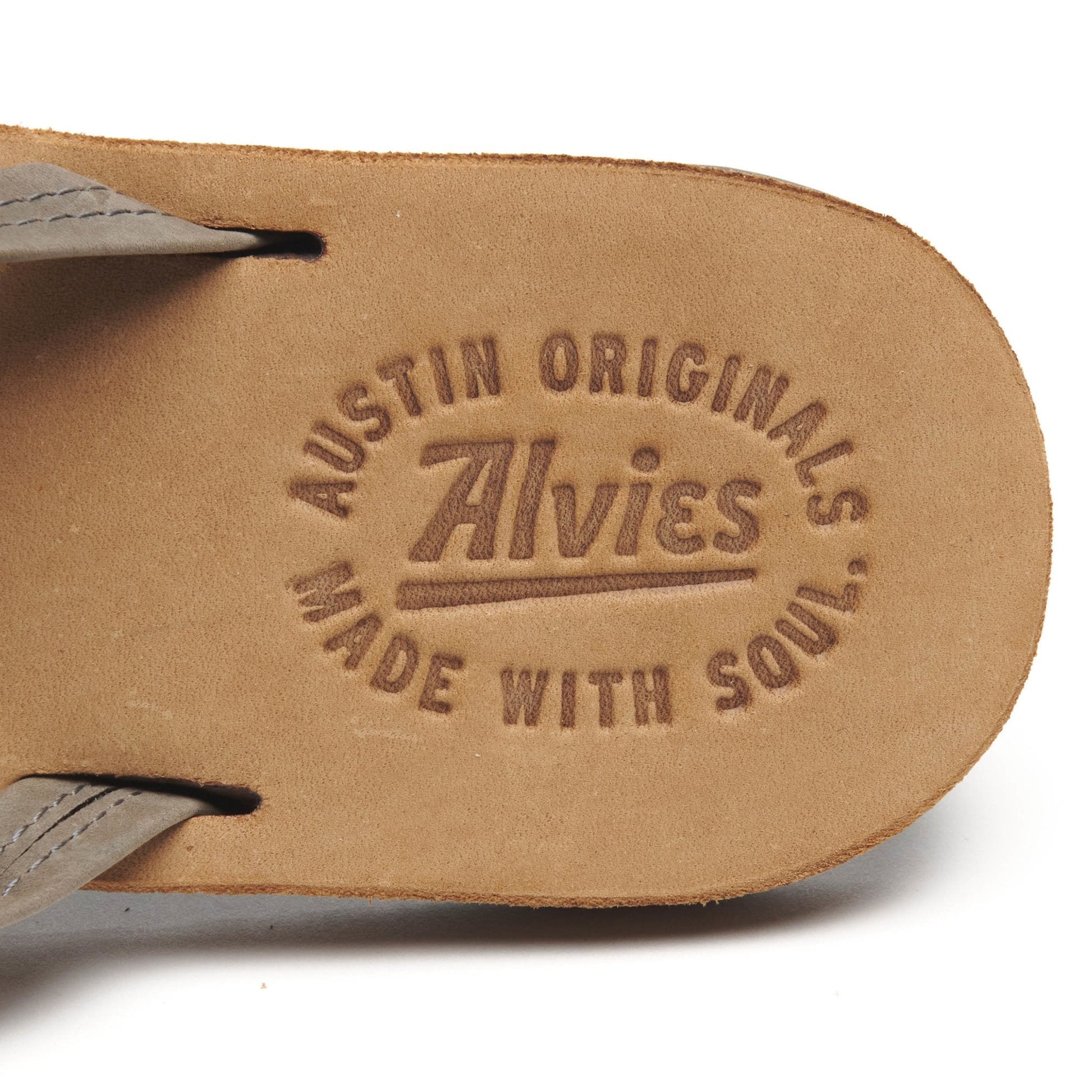 Close-up of gray flip-flop insole with “AUSTIN ORIGINALS” logo embossing