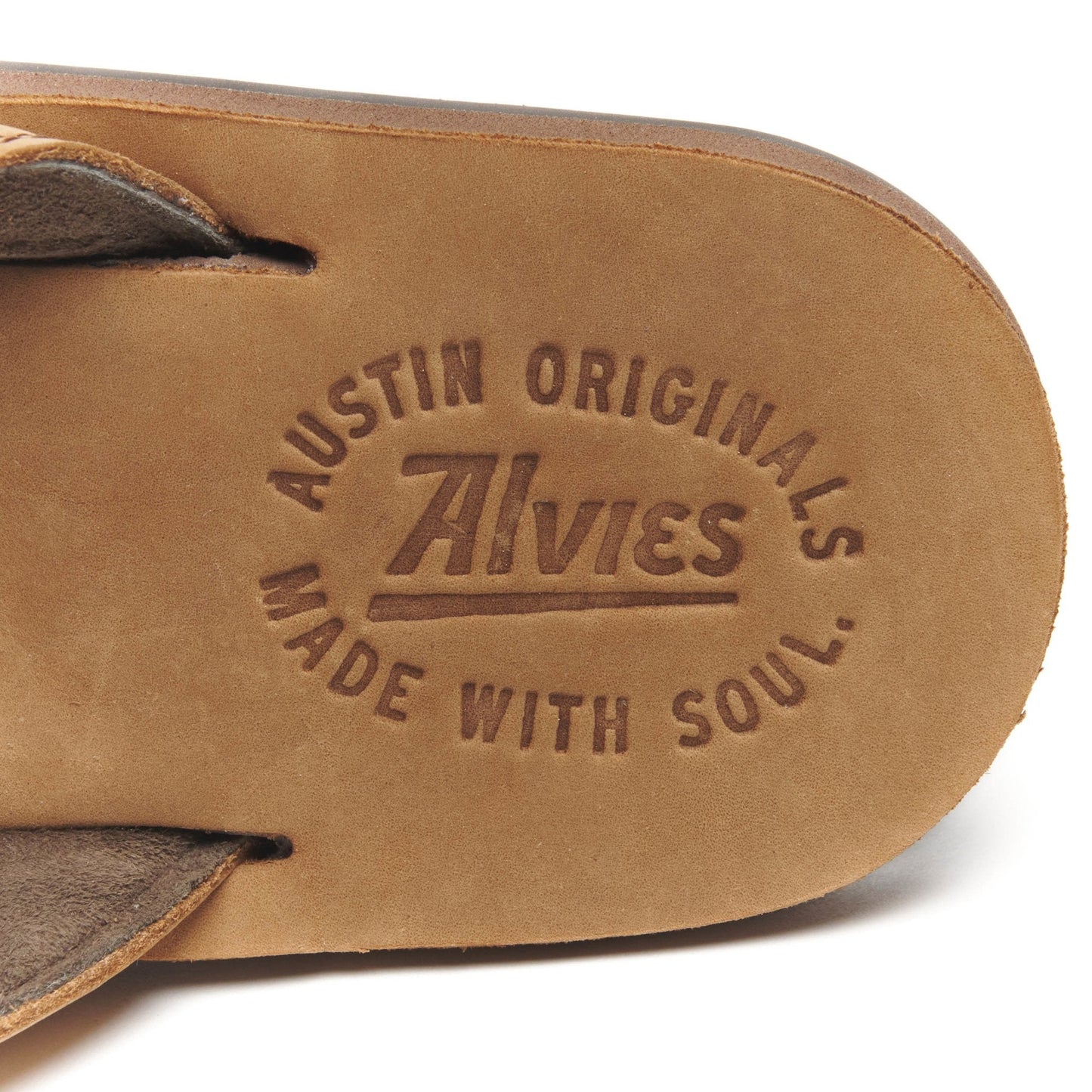 Tan suede flip-flop footbed with embossed Austin Originals logo.