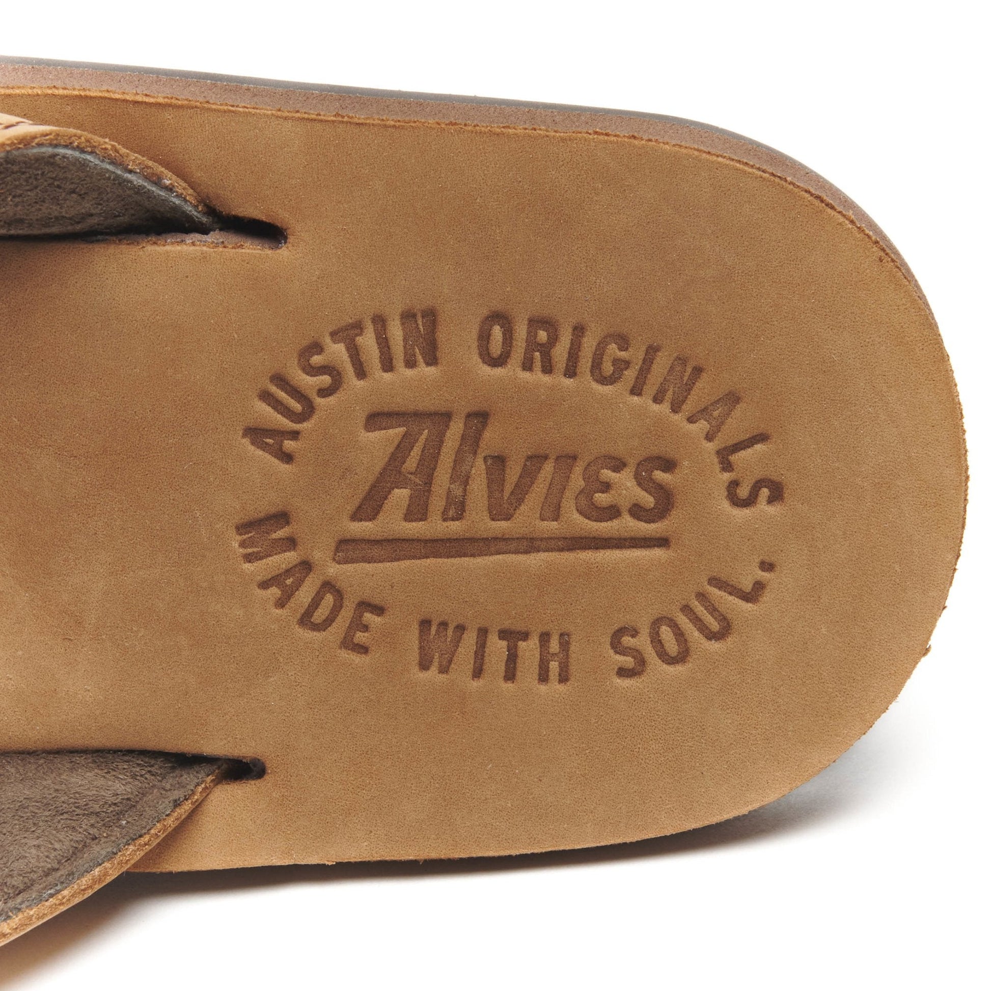 Tan suede flip-flop footbed with embossed Austin Originals logo.