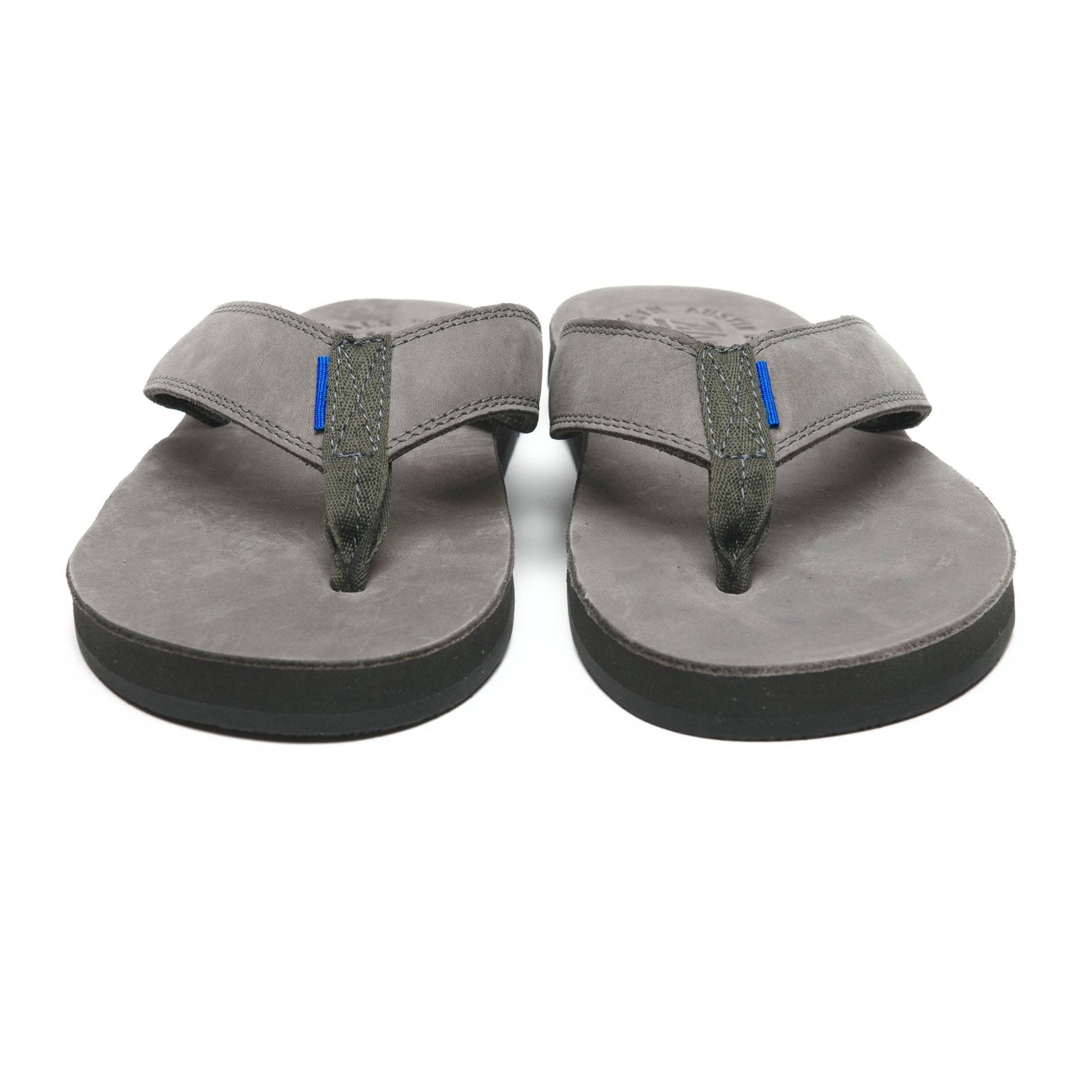 Pair of gray flip-flop sandals with greenish thong straps and blue accent tab