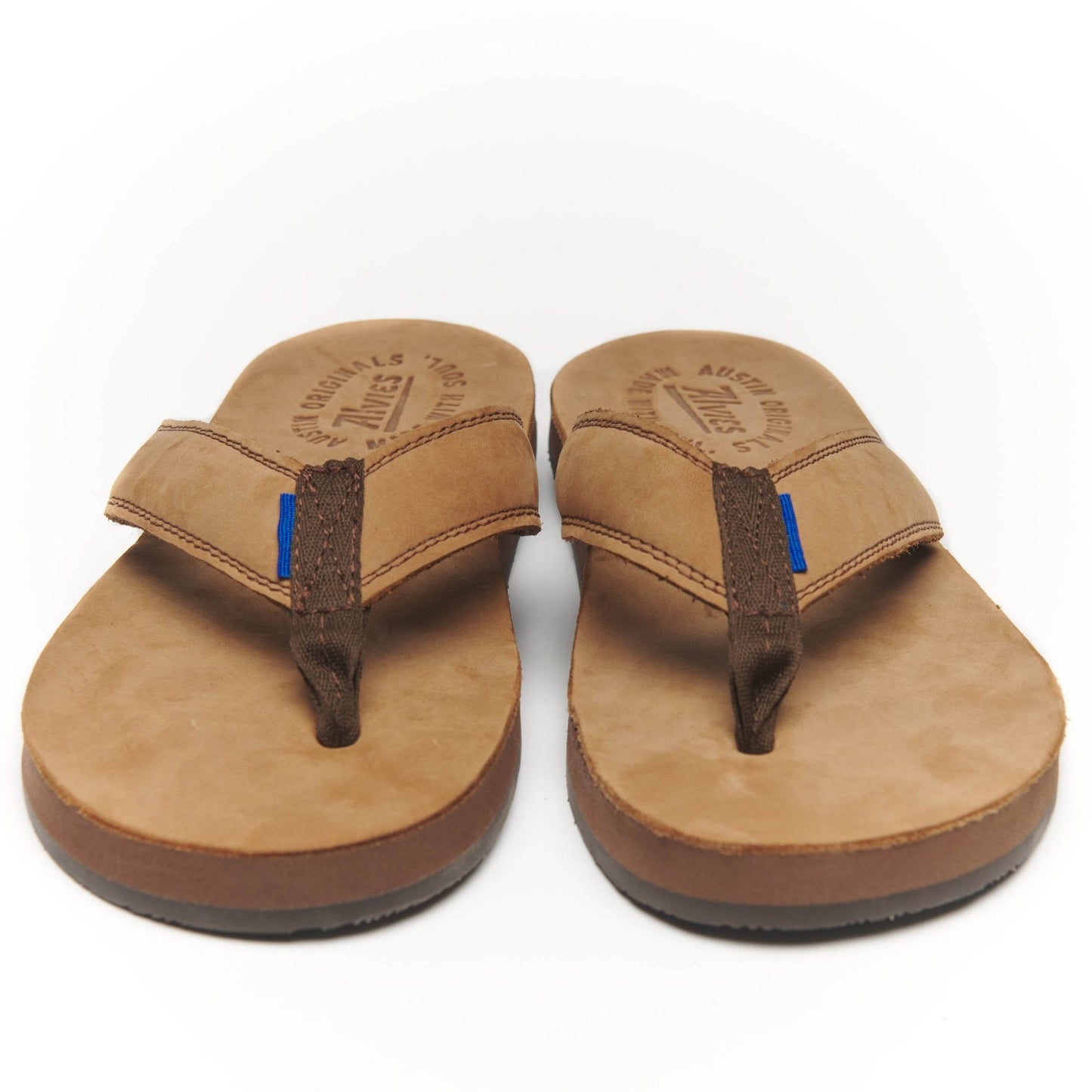 Tan suede flip-flops with black thong straps and blue stitch accents.