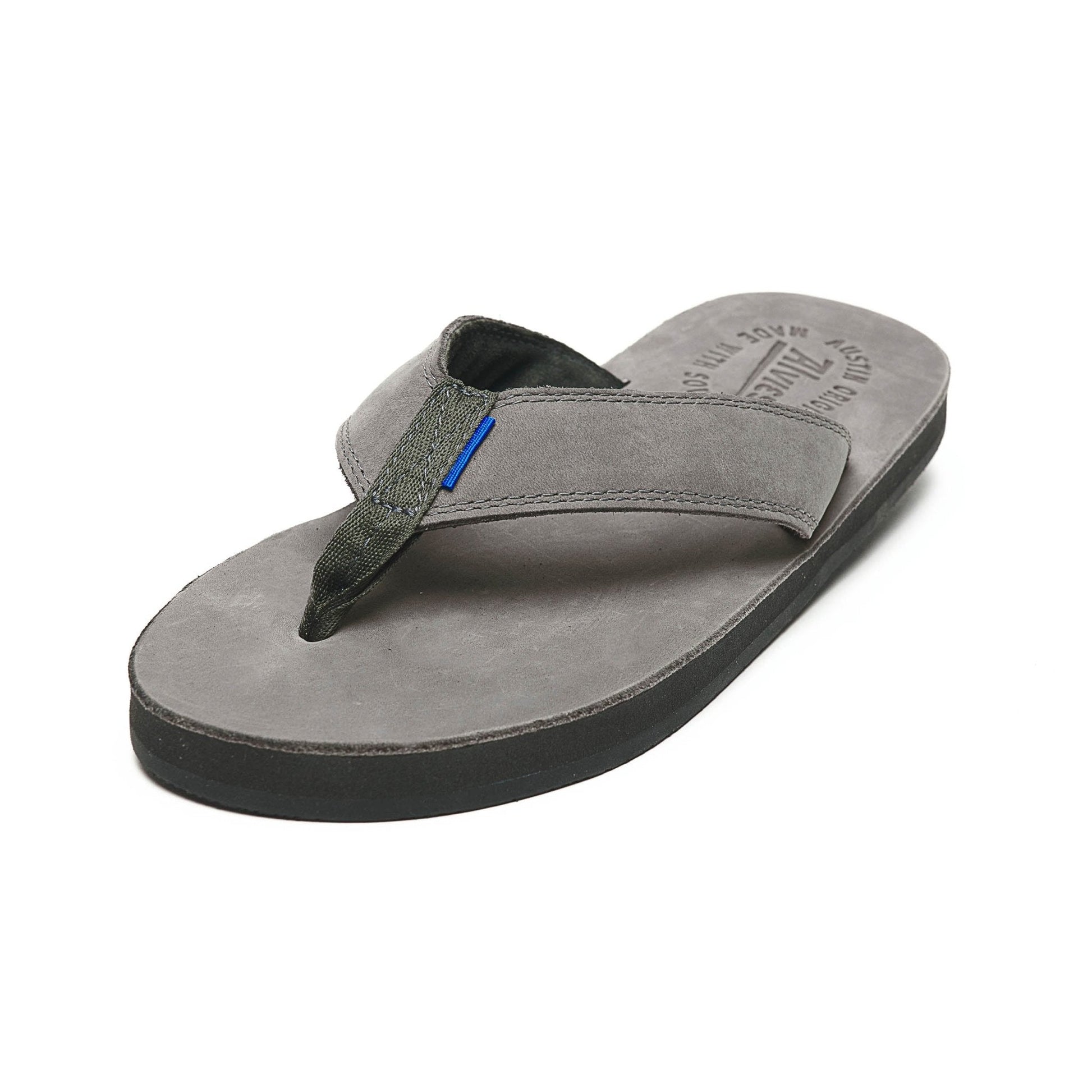 Gray thong sandals with black insole and blue accent detail, front 3/4 view