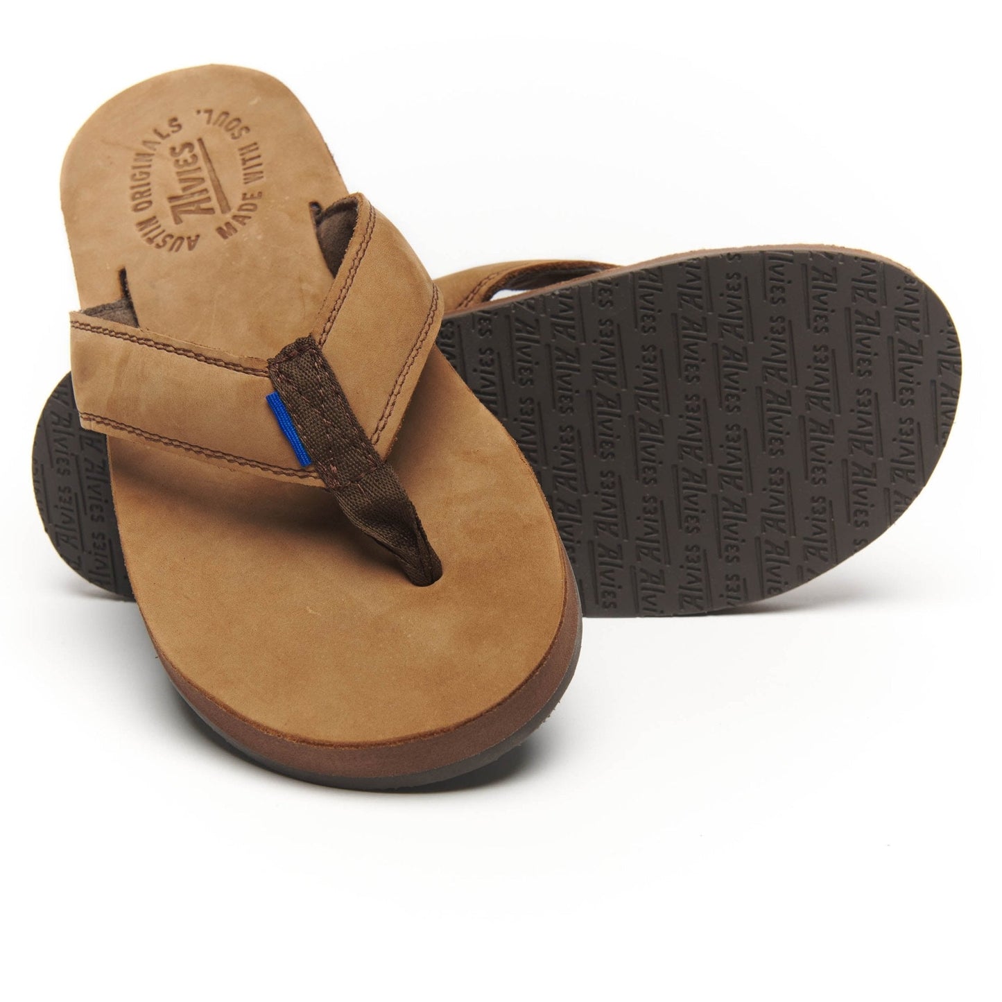 Tan suede flip-flops with black thong straps and textured rubber outsole.
