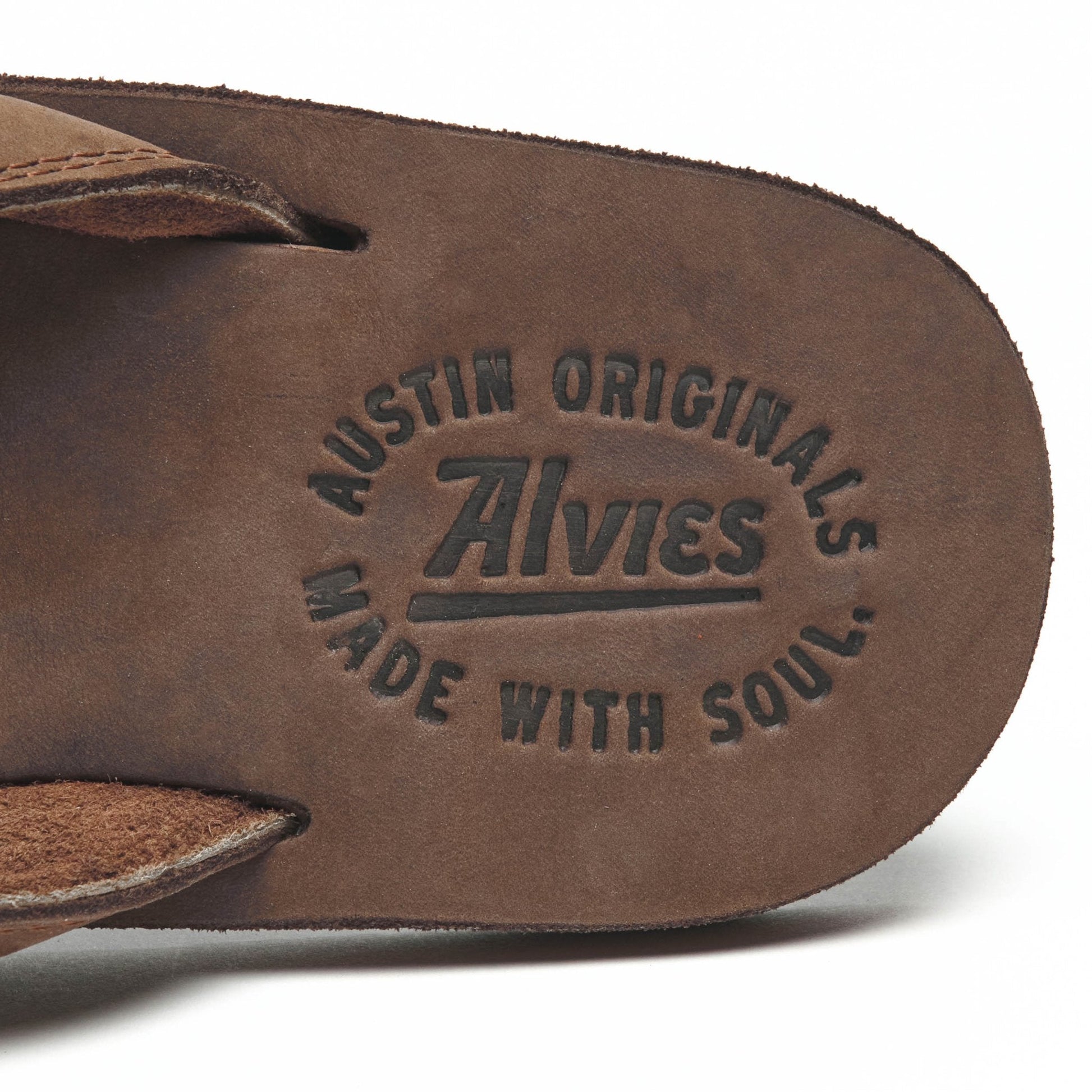 Brown flip-flop footbed sole close-up with embossed logo