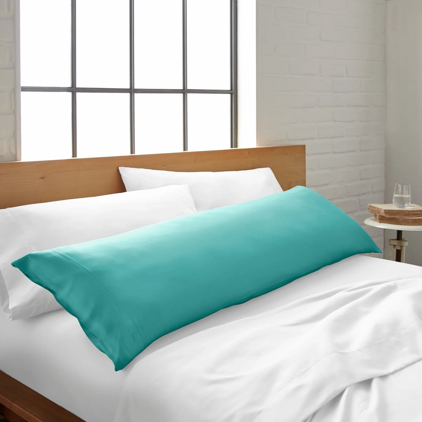 Bamboo body pillowcase in tiffany blue, laid across a white bed sheet