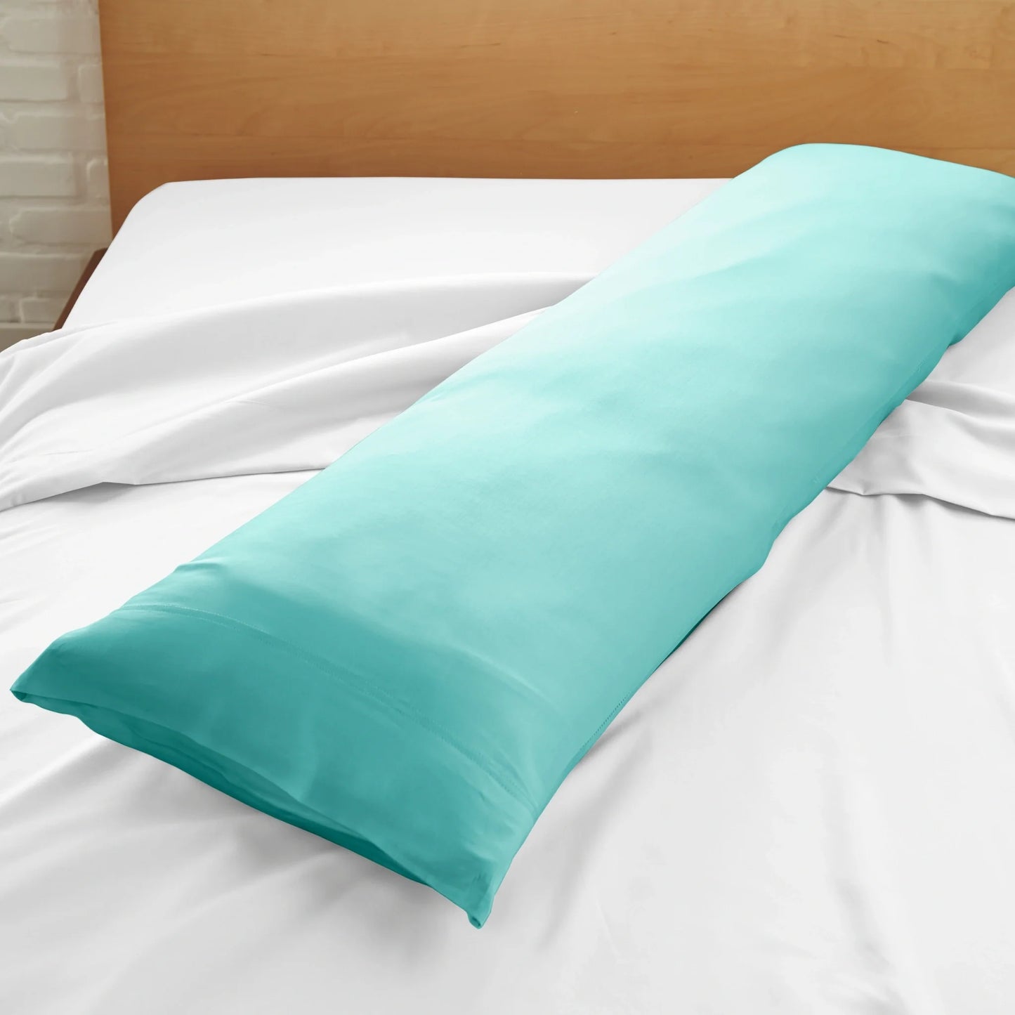 Bamboo body pillowcase in tiffany blue, close view on a white bed sheet