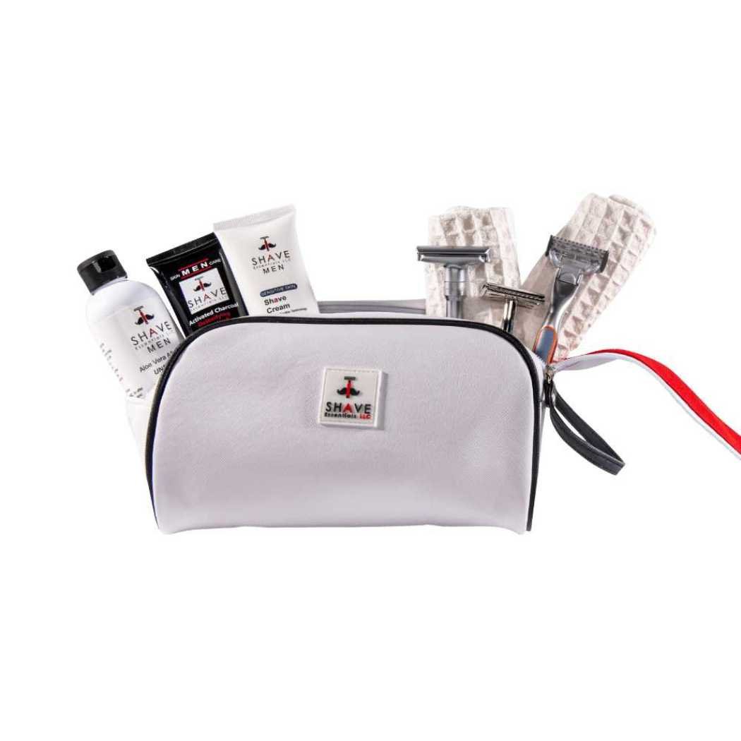 Light gray toiletry bag with front logo patch, black zipper and strap, shown with toiletries