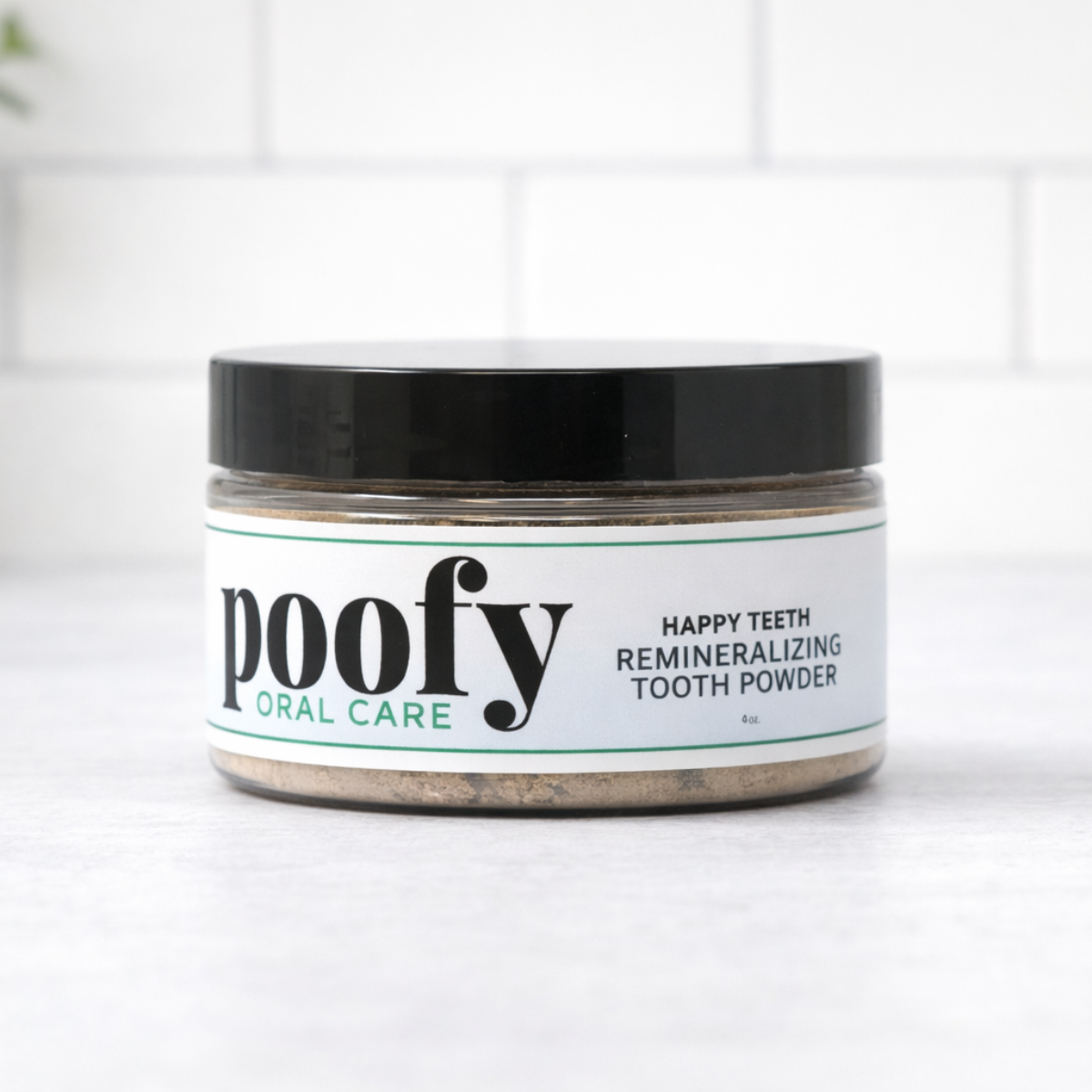 Happy Teeth remineralizing tooth powder jar, black lid, white label.