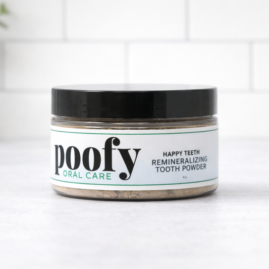 Happy Teeth remineralizing tooth powder jar, black lid, white label.