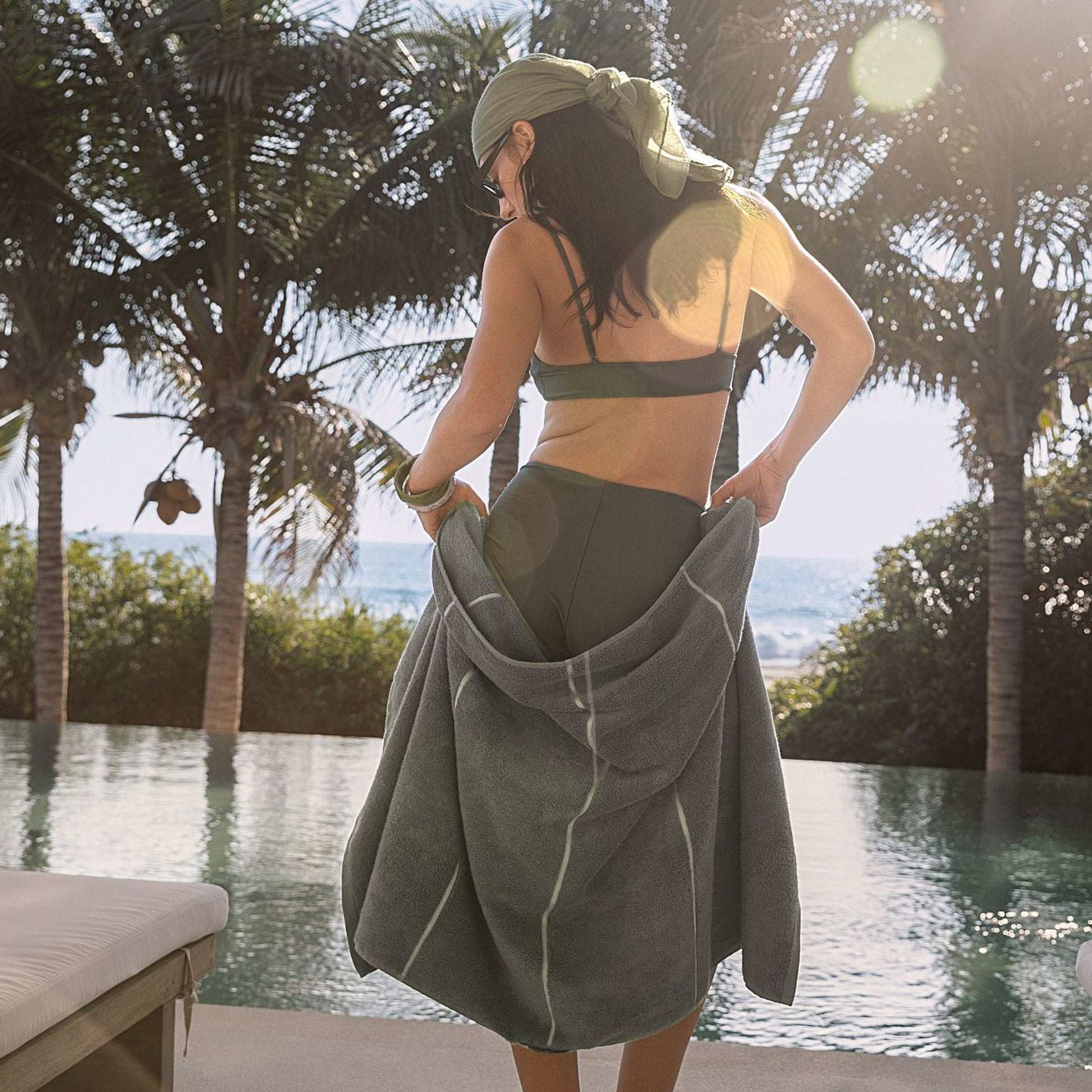 Sage green cotton hooded towel wrap, worn with hood over shoulders