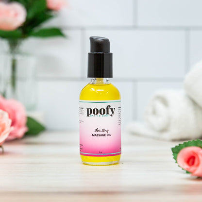 Massage oil bottle with black pump; yellow bottle with pink gradient label.