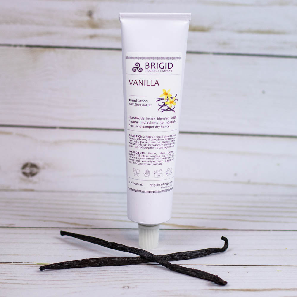 Vanilla hand lotion squeeze tube with vanilla flower on countertop