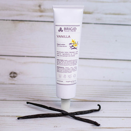 Vanilla hand lotion squeeze tube with vanilla flower on countertop