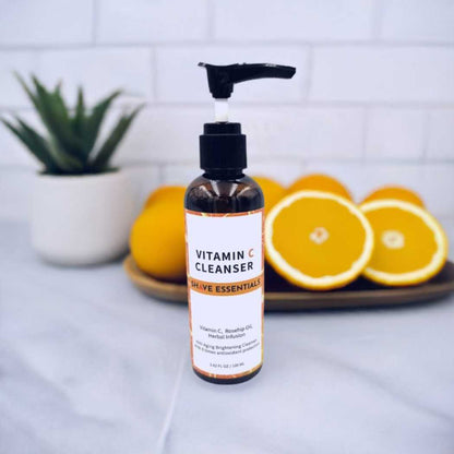 Vitamin C facial cleanser bottle with pump on tray with citrus slices