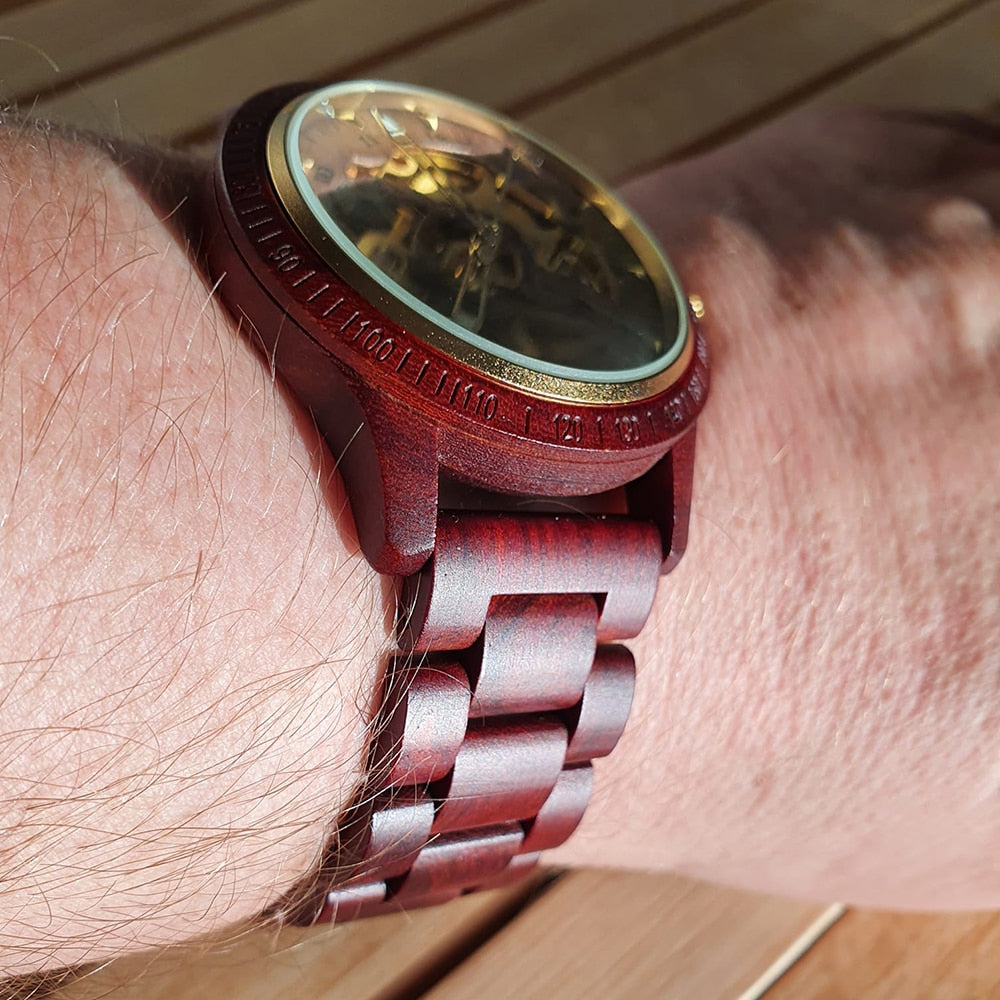 Men’s mechanical wooden watch on wrist with dark brown strap and open dial