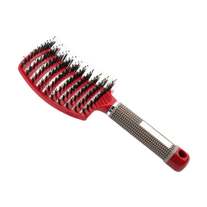 Red massage hair comb with textured grip handle and dense mixed bristles