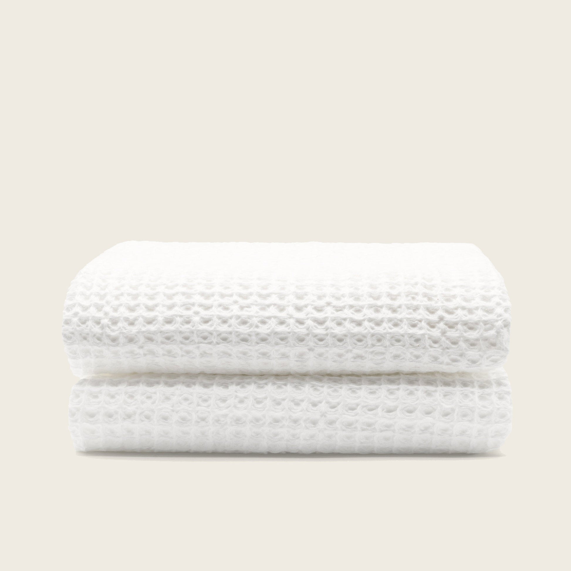 Australian cotton waffle towels in white, neatly folded with waffle pattern